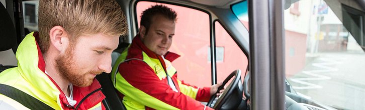 Zwei Personen in einem Rettungswagen.