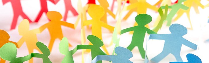 Bunte Menschenkette aus Papierfiguren.